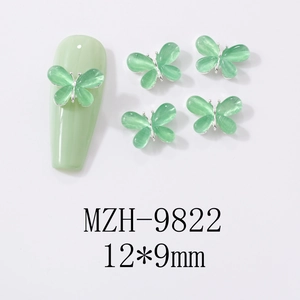 Macro view of 12x9mm mint green cat-eye butterfly nail art charm with silver metal edge