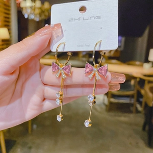 Macro detail of elegant long tassel earrings with S925 silver needles and pink stones