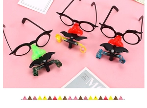 Funny party glasses featuring large nose, black mustache, and built-in colorful blow whistles