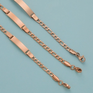 Macro view of rose gold stainless steel kids bracelets with engravable ID plate charms
