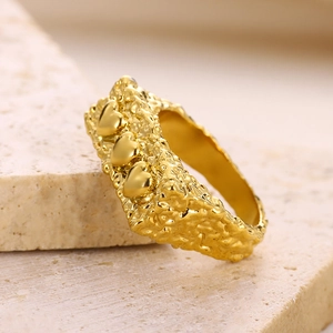 Irregular textured gold heart ring with lava hammer finish and open adjustable design