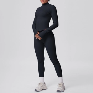 Dettaglio del set yoga nero aderente con maglia a collo alto con zip e pantaloni sportivi