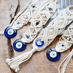 Handmade macrame evil eye wall hanging with white cotton rope and blue glass beads