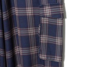 Detailed macro view of blue plaid cargo pants featuring red and white checkered pattern