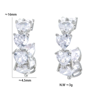 Detail view of C-shaped earrings with heart-cut cubic zirconia and silver plating