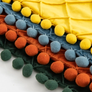 Velvet diamond quilted pillow covers with pompom fringe in yellow, blue, orange and green