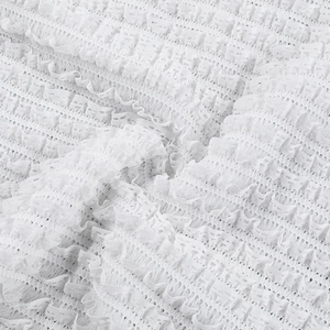 Detailed macro view of white layered lace fabric with delicate pleated texture and mesh