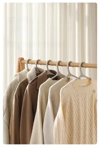 Strong plastic clothes hanger supporting heavy winter coat with 4.5kg load capacity