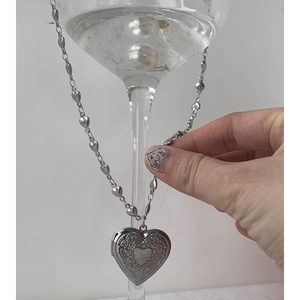 Vintage silver heart locket necklace with floral engraving and red heart on heart-shaped chain