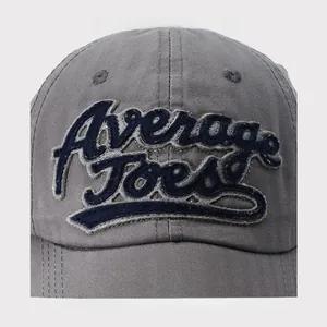 Detail of vintage gray cotton baseball cap featuring blue Average Joe's 3D embroidery