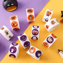 Flat lay view of Halloween sticker rolls featuring cartoon pumpkin, ghost, and bat patterns