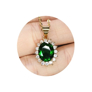 Classic green emerald pendant necklace with white zircon border on a gold plated chain