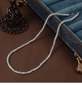 French irregular natural freshwater pearl necklace displayed in a luxury jewelry box