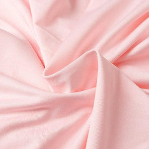 Macro view of pink knitted diagonal weave fabric showing detailed textile texture