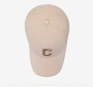 Top-down view of beige baseball cap with brown embroidered letter C and clean fabric