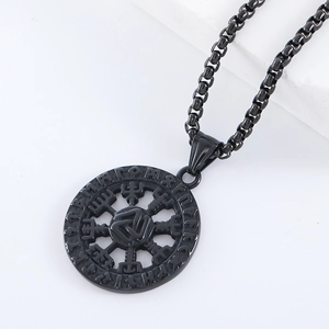 Macro shot of Viking Valknut and Elder Futhark runes on a black steel pendant