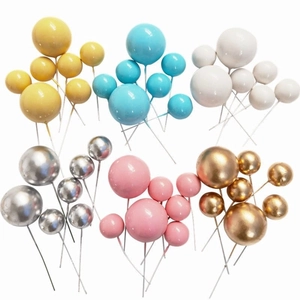 Detailed view of colorful gold and silver decorative cake balls in various sizes