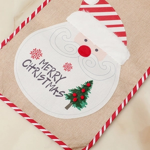 Detail of Christmas burlap table runner with Santa Claus embroidery and Merry Christmas text