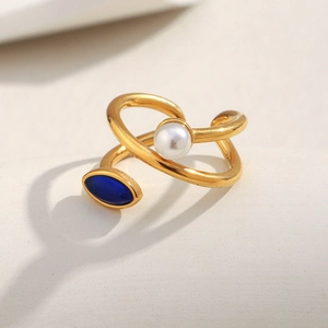 Detailed view of 18K gold-plated asymmetrical ring with blue stone and pearl