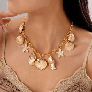 Detailed view of a gold ocean-themed necklace with starfish and seashell charms