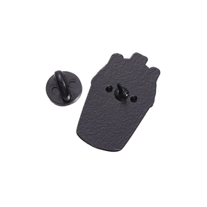 Macro detail of the matte black metal brooch back with secure black rubber clutch butterfly back