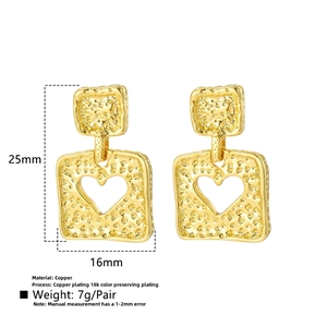 Detail view showing 25mm gold-plated square heart earrings with hammered texture
