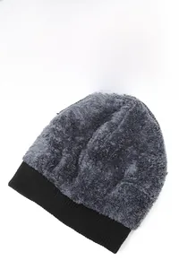 Detail showing the thick plush texture and black knit brim of this warm winter beanie