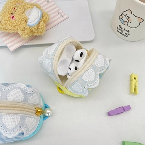 Close-up of cute light blue checkered earphone pouch with lace heart and pearl zipper