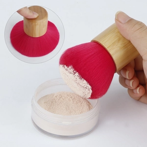 Bamboo handle powder brush with soft pink bristles showing high density and elasticity