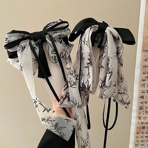 Elegant Chinese bow hair clip with black bamboo print ribbons and tassel details