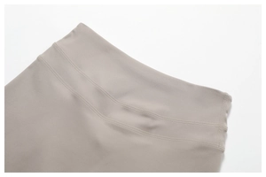 Detail shot of the wide high-waist band and double-stitch seam on khaki yoga pants