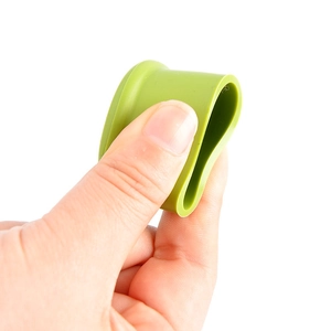 Flexible food-grade silicone beer bottle cap in green showing elasticity and softness