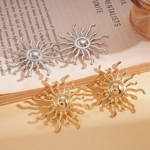 Elegant gold and silver sunburst brooches set on a book in stylish lighting