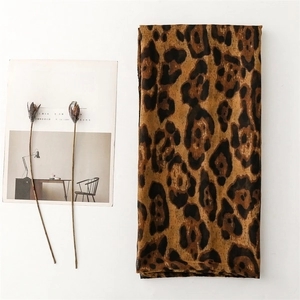 Detail of leopard print scarf fabric texture with a minimalist artistic magazine background