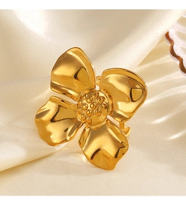 Detailed close-up of 18K gold plated stainless steel flower ring on beige silk