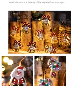 Macro detail of LED Christmas light string with Santa, bells and candy cane shapes