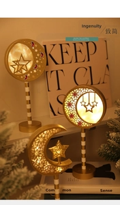 Close-up of golden wooden moon and star LED lights for festive home atmosphere
