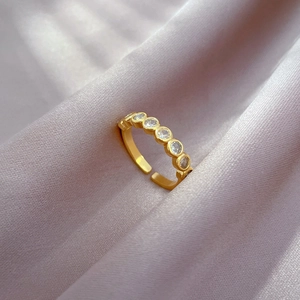 Adjustable gold plated open ring featuring six sparkling round cubic zirconia stones