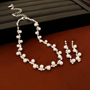 Elegant silver jewelry set featuring geometric pearl and rhinestone necklace with stud earrings