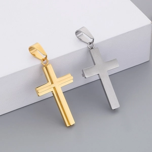 Detail view of gold and silver cross pendants featuring brushed stainless steel texture