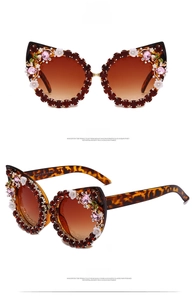 Close-up of cat-eye sunglasses with tea rhinestones and small floral decorations
