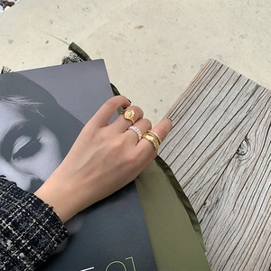 Stacked set of gold portrait rings and double-layer white freshwater pearl ring