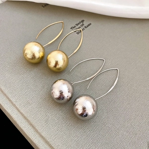 Minimalist metallic ball drop earrings with brushed texture in gold and silver finish