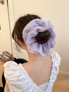 Detail of light purple layered ruffle scrunchie with sheer organza texture on hair bun