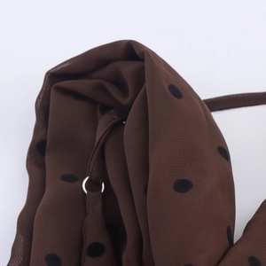 Detailansicht aus Chiffon in Dunkelbraun mit Punkten und silbernem Metallring-Verbinder