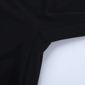 Close-up of durable reinforced stitching on black athletic knit bodysuit fabric