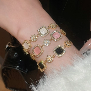 Vue détaillée de bracelets plaqués or 18k avec pierres carrées blanches, roses et noires