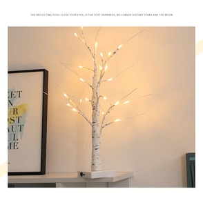 Macro view of realistic birch bark texture and warm yellow LED beads on decorative tree
