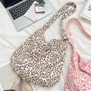 Detail of leopard print and pink heart canvas bags with wide shoulder straps