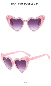 Detail of light pink heart sunglasses with sparkling rhinestones and gradient lenses
